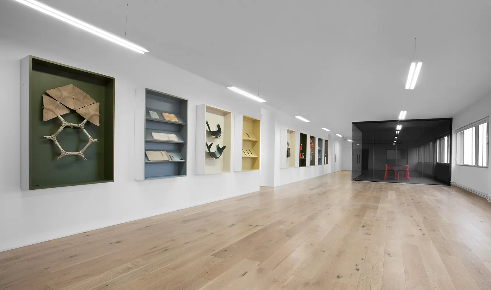 Material library shelves with samples and textures at LAYER's industrial design studio in London.