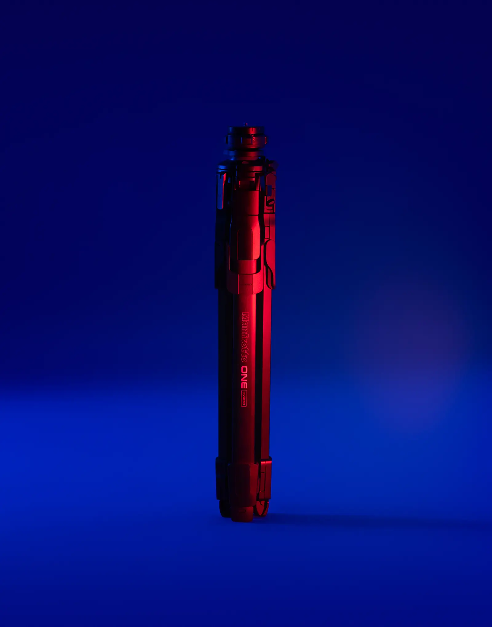 The ONE tripod by leading industrial design consultancy LAYER shown folded and upright against a blue background.