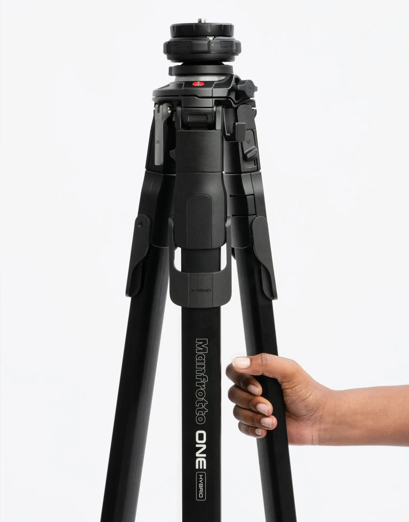 A person gripping the ONE tripod by leading industrial design consultancy LAYER while it stands on a white background.